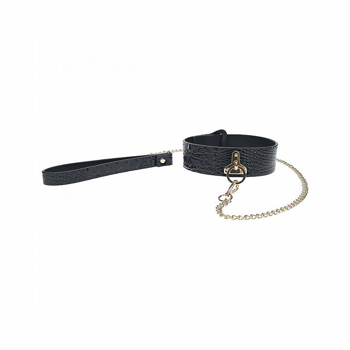 Black textured bonded leather collar with gold chain leash and iridescent hardware detail.