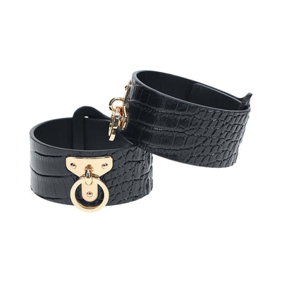 Black faux crocodile leather leg cuffs with gold-tone hardware and adjustable straps for secure fit.