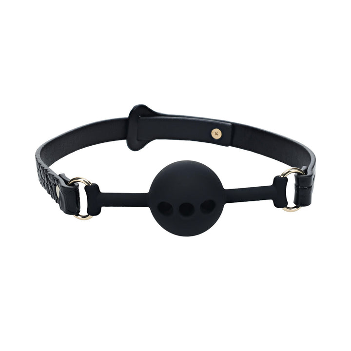 Black silicone ball gag with adjustable bonded leather straps and gold-tone hardware on a white background.