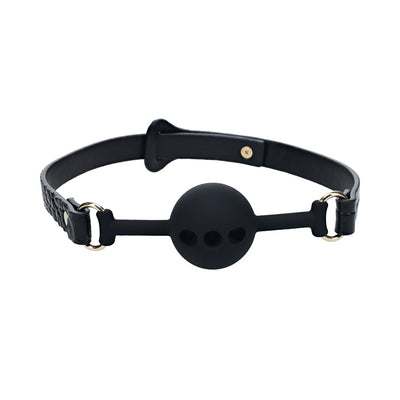 Black silicone ball gag with adjustable bonded leather straps and gold-tone hardware on a white background.