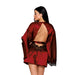 Woman wearing an oxblood satin robe with open back and black lace detailing on sleeves and waist.