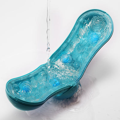 Open Tenga Flip Orb Ocean Blue showing textured interior with water pouring over it for easy cleaning.