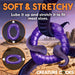 Purple stretchy silicone ring with textured spikes, shown fitting around a tentacle in a desert background.