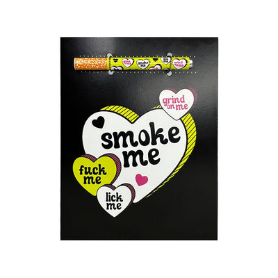 Black greeting card with colorful hearts and bold playful text, including a matching one-hitter pipe attached at the top.