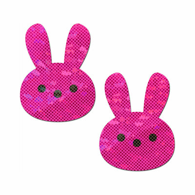 Pair of glittery pink bunny-shaped nipple pasties with black dot eyes and nose on a white background.