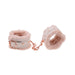 Peach-colored faux fur handcuffs with rose gold hardware and adjustable buckle, connected by a short chain.