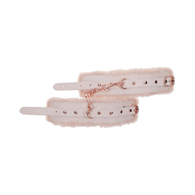 Light peach faux fur handcuffs with adjustable white straps and rose gold chain and hardware detail.