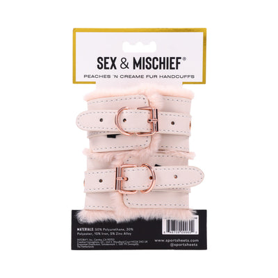 Light peach faux fur handcuffs with adjustable rose gold buckles on branded Sex & Mischief packaging.