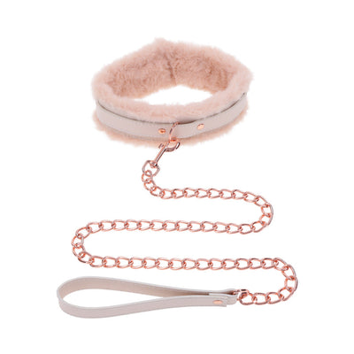 Peach-colored faux fur collar with matching rose gold chain leash and faux leather handle on white background.
