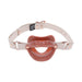 Peach pearlescent silicone lip-shaped gag with adjustable beige faux leather strap and rose gold hardware accents.