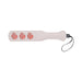 Light pink faux leather paddle with three peach-shaped cutouts and attached black wrist strap.