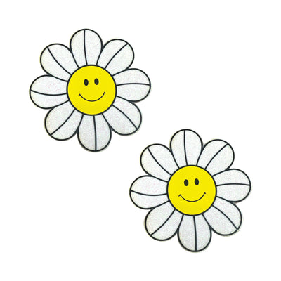 Pair of glittery white daisy-shaped pasties with yellow smiley face centers and black petal outlines.