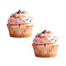 Pair of edible cupcake-shaped nipple pasties with pink frosting and colorful sprinkles on white background.