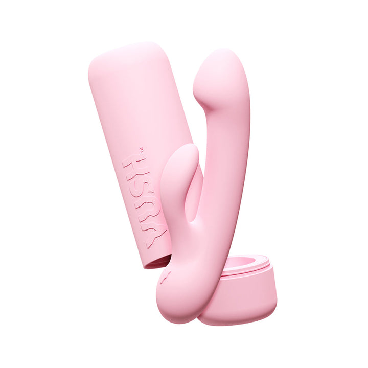 Pink dual-stimulation VUSH Glow Rabbit Vibrator with sleek storage case on white background.
