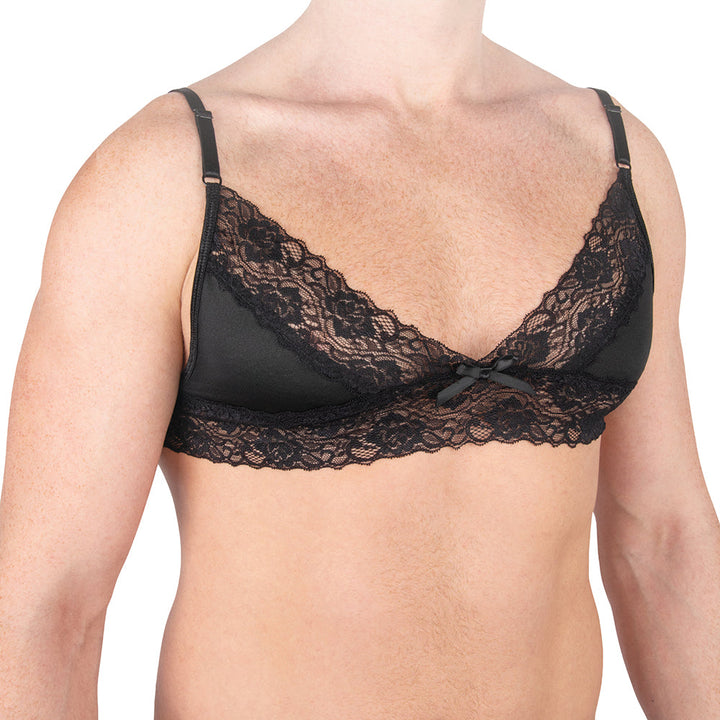 Black lace bra with delicate floral patterns and adjustable straps worn on a male model's torso.