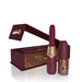 Merlot-colored rechargeable vibrating lipstick with gold accents and leopard print packaging box open on white background.