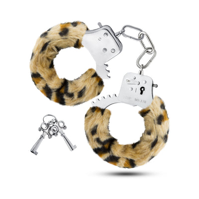 Pair of stainless steel handcuffs with removable leopard print faux fur covers and two matching keys on a white background.