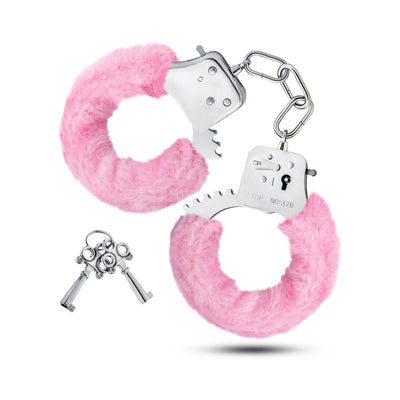 Pair of stainless steel handcuffs with soft pink faux fur lining and two small silver keys on a white background