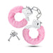 Pair of stainless steel handcuffs with soft pink faux fur lining and two small silver keys on a white background