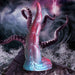 Iridescent red and blue silicone tentacle dildo with textured suckers and wide suction base on a rocky shore background.