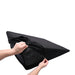 Hands unzipping the black removable cover of a triangular foam wedge positioner with water-resistant liner.