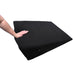 Black wedge-shaped sportsheets pivot positioner plus with a hand pressing down to show its soft foam texture.