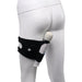 Black adjustable thigh strap worn on a mannequin leg, holding a white wand vibrator securely in place.