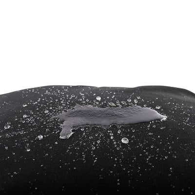 Close-up of black Sportsheets Pivot Pillow Protector showing water beading on its waterproof surface.