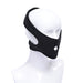 Black neoprene face strap-on harness displayed on a white mannequin head with adjustable hook and loop closures.