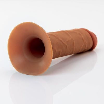 Brown hollow silicone strap-on with realistic texture and flared base on a white background.
