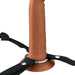 Brown 7-inch hollow silicone strap-on with black adjustable nylon harness and metal ring base on white background.