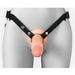 Front view of a realistic flesh-toned hollow silicone strap-on with black adjustable nylon harness on a gray mannequin.
