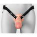Front view of a realistic flesh-toned hollow silicone strap-on with black adjustable nylon harness on a gray mannequin.