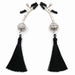 Pair of silver-tone adjustable nipple clamps with black rubber tips and decorative black tassels on a white background.
