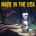Bottle of Creature Slime unscented lubricant with monster-themed label, placed on wooden surface with spilled liquid and American flag background.