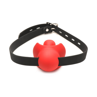 Red silicone ball gag with mouthguard design and adjustable black vegan leather strap with silver buckle on white background.