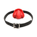 Red silicone extreme gag with black adjustable locking strap and silver buckle on white background.