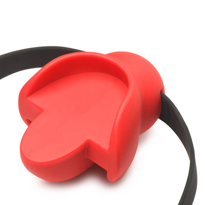 Red silicone mouthguard gag with black adjustable locking strap on white background.
