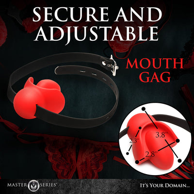 Red silicone mouth gag with black adjustable strap and nickel-free buckle, shown with size measurements on dark background.