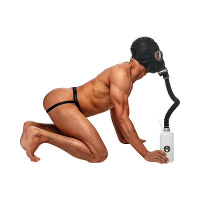 Muscular person kneeling wearing a black rubber gas mask connected by hose to a white aroma bottle, dressed in minimal black straps.