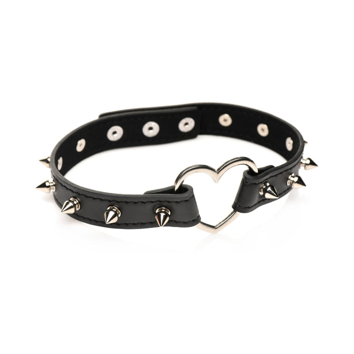 Black vegan leather choker with silver spikes and a heart-shaped metal centerpiece, adjustable with snap closures.