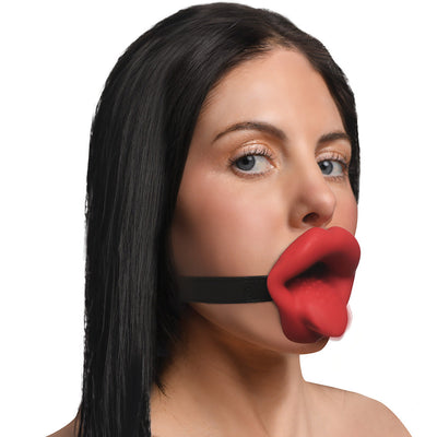 Woman wearing a Master Series Vibrating Lips Mouth Gag with red lips design and black adjustable strap