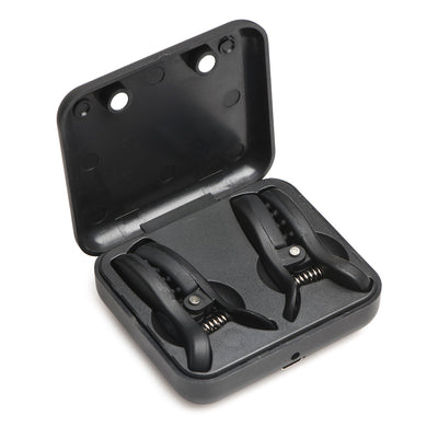 Black vibrating nipple clamps with grippy nubs stored inside a compact rechargeable travel case.