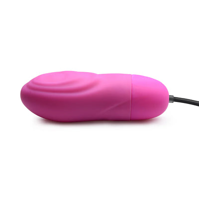 Pink rechargeable silicone bullet vibrator with textured ridges and attached control cord on white background.