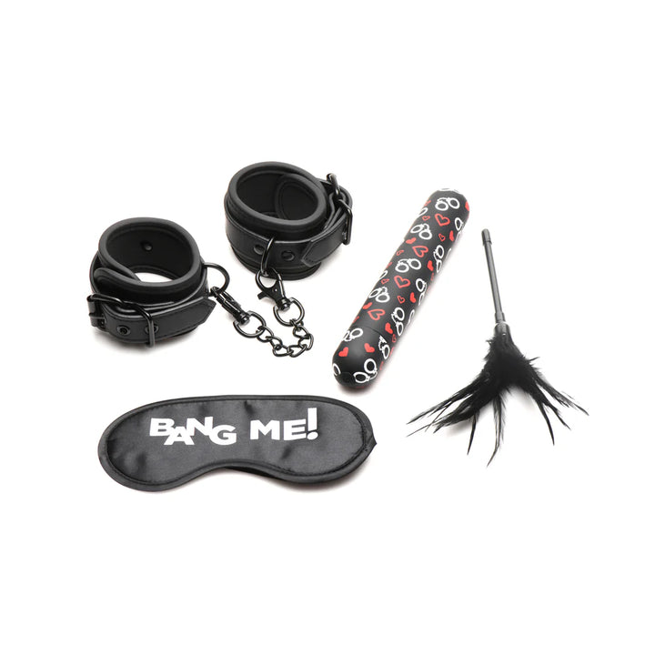 Black bondage kit with faux leather wrist cuffs, patterned bullet vibrator, feather tickler, and satin blindfold with text "BANG ME!"