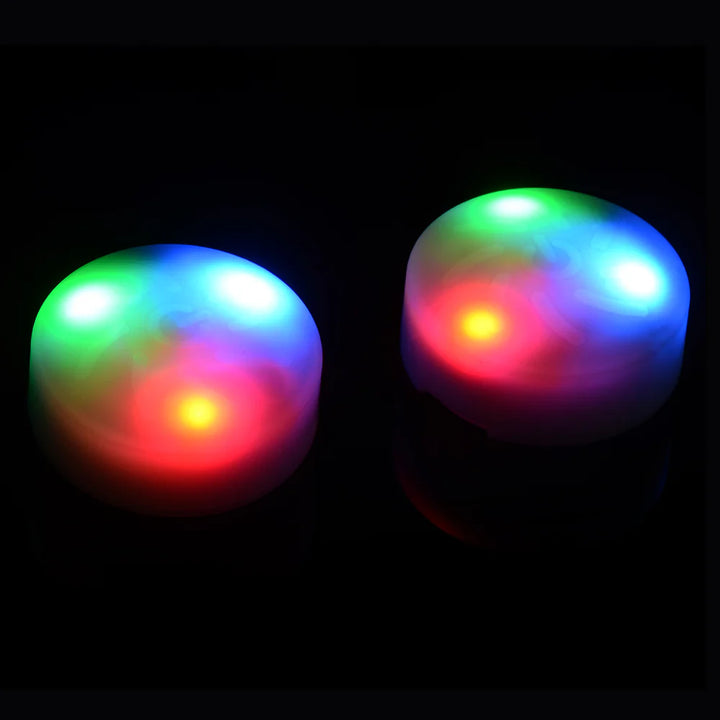 Two glowing LED light discs with vibrant red, green, and blue colors against a black background.