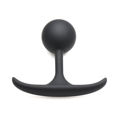 Small black silicone anal plug with a weighted round bulb and slim curved base for comfortable wear.