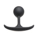 Small black silicone anal plug with a weighted round bulb and slim curved base for comfortable wear.