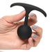 Hand holding a small black silicone weighted anal plug with a round bulb and slim T-shaped base.