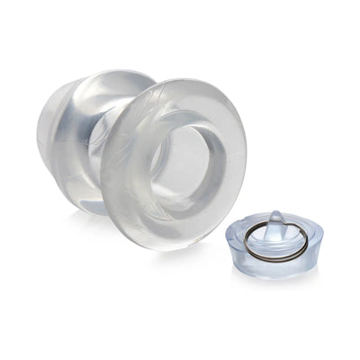 Transparent hollow anal dilator with removable plug and metal ring, made from firm flexible TPE material.